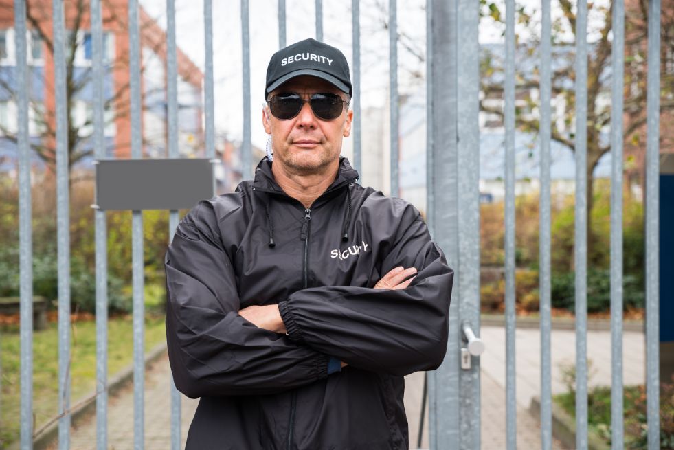 Security guard in front of gate